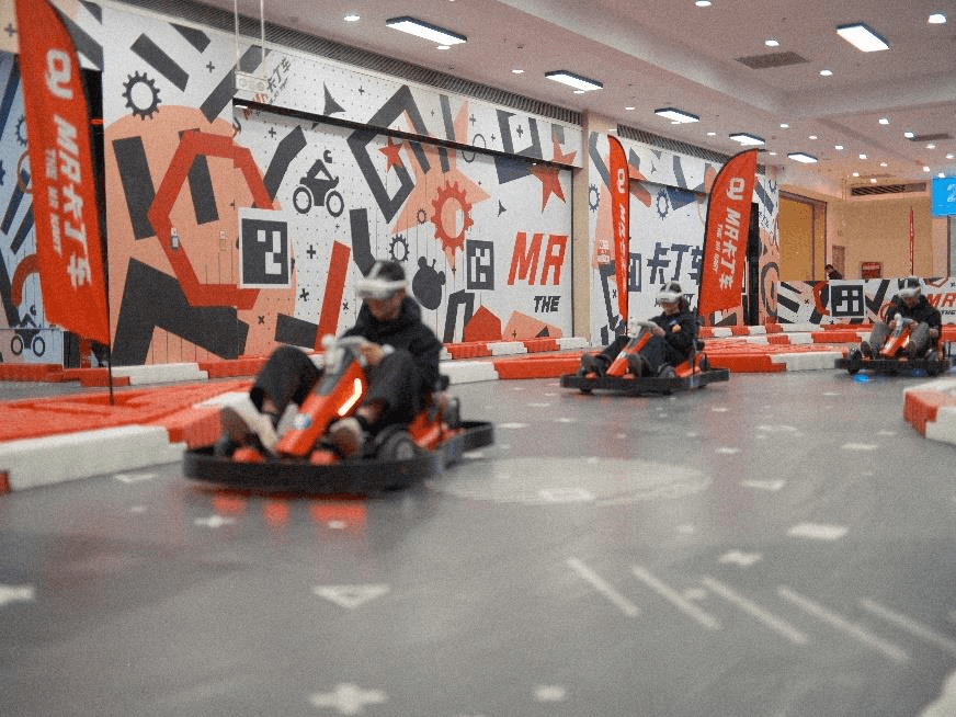 Guests driving MR Karts in an indoor venue