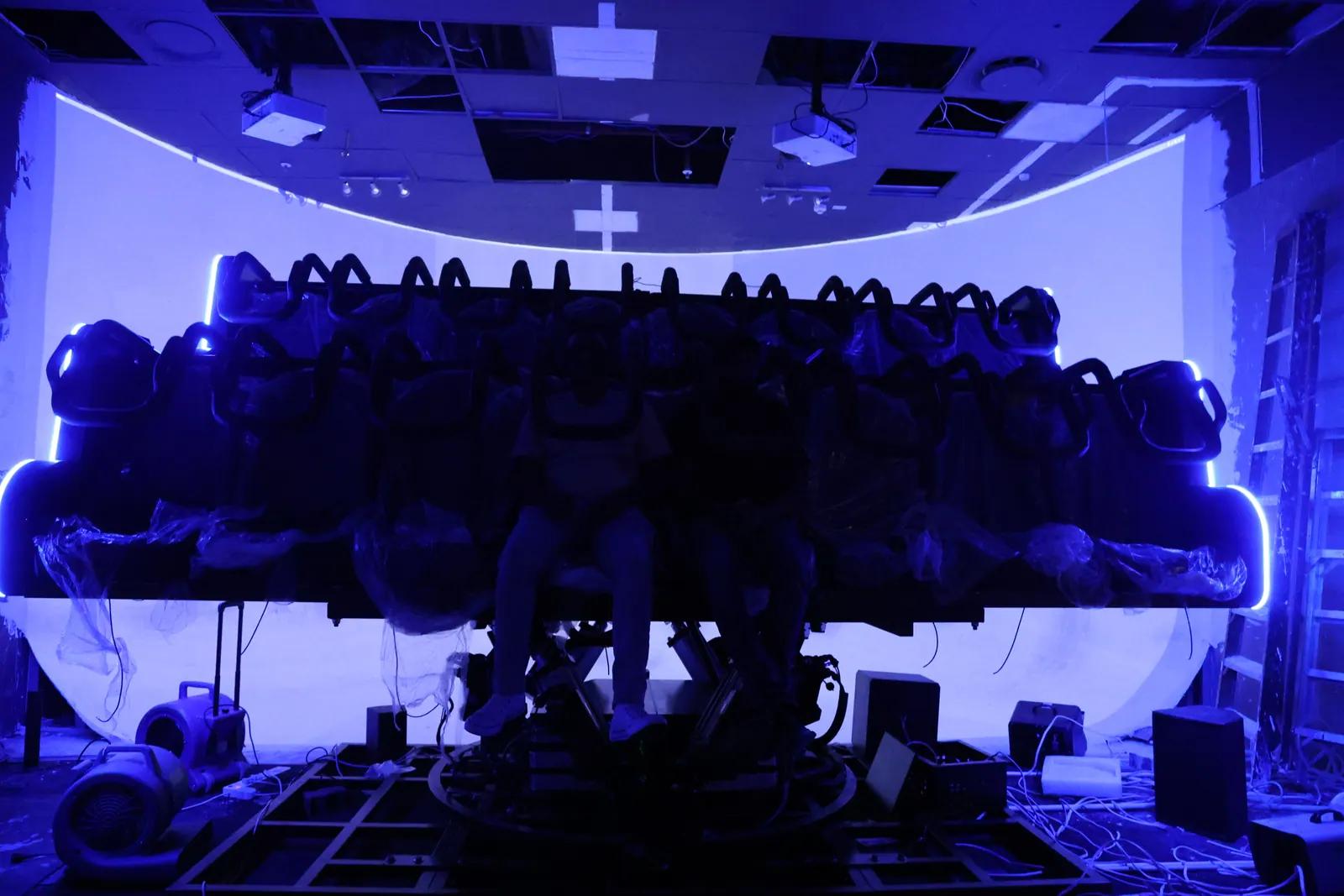 Installed flying theater with curved screen and motion seats