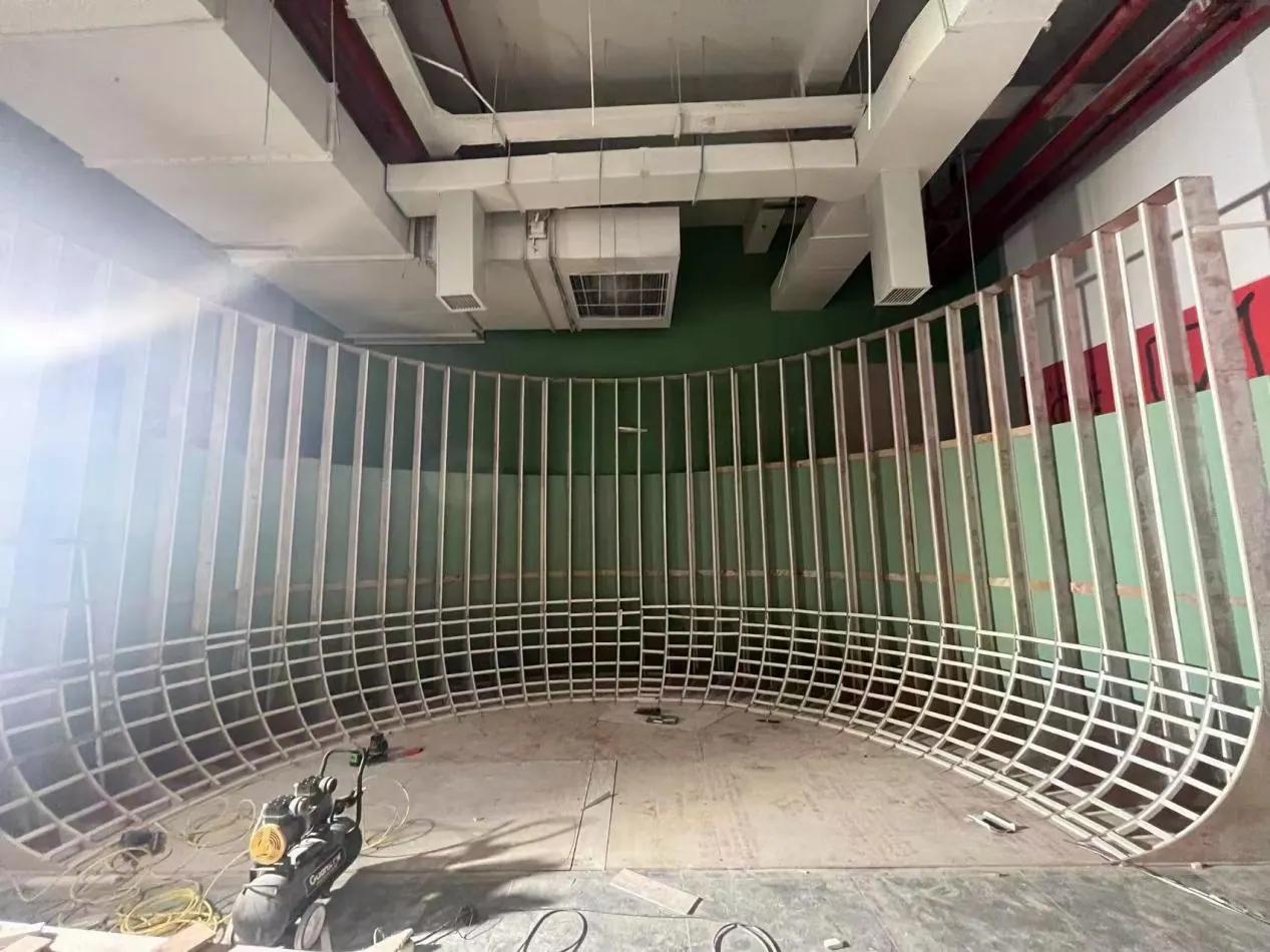 Flying theater technicians working on ceiling and equipment installation