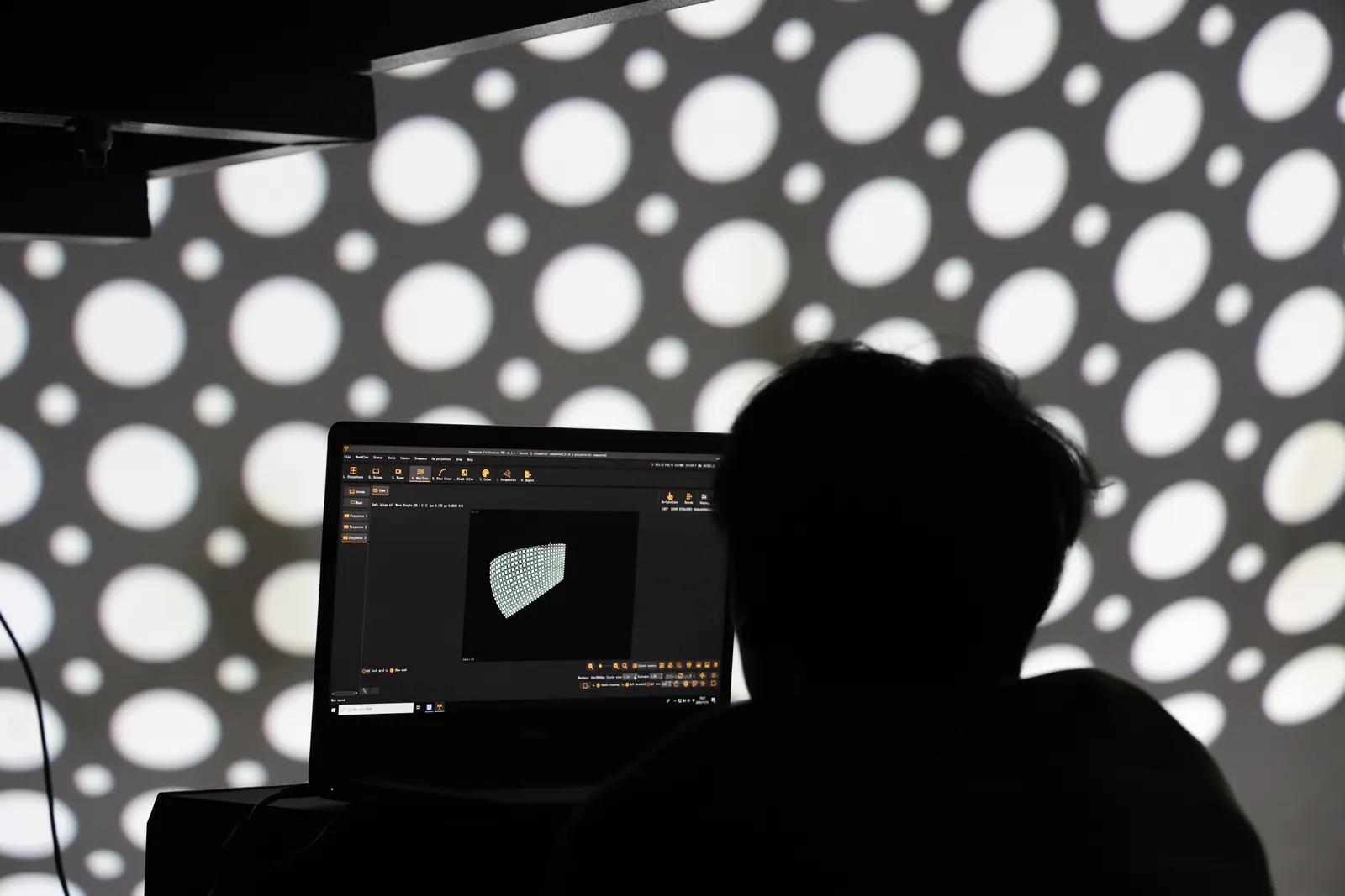 Technician calibrating flying theater projection and control software